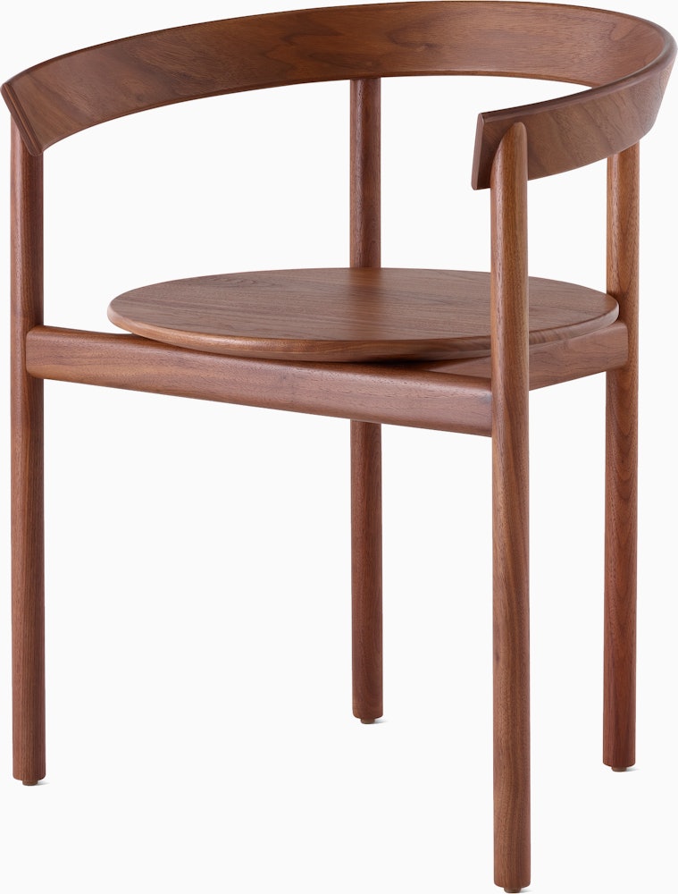 A walnut Comma Chair with arms, viewed from the front at an angle.