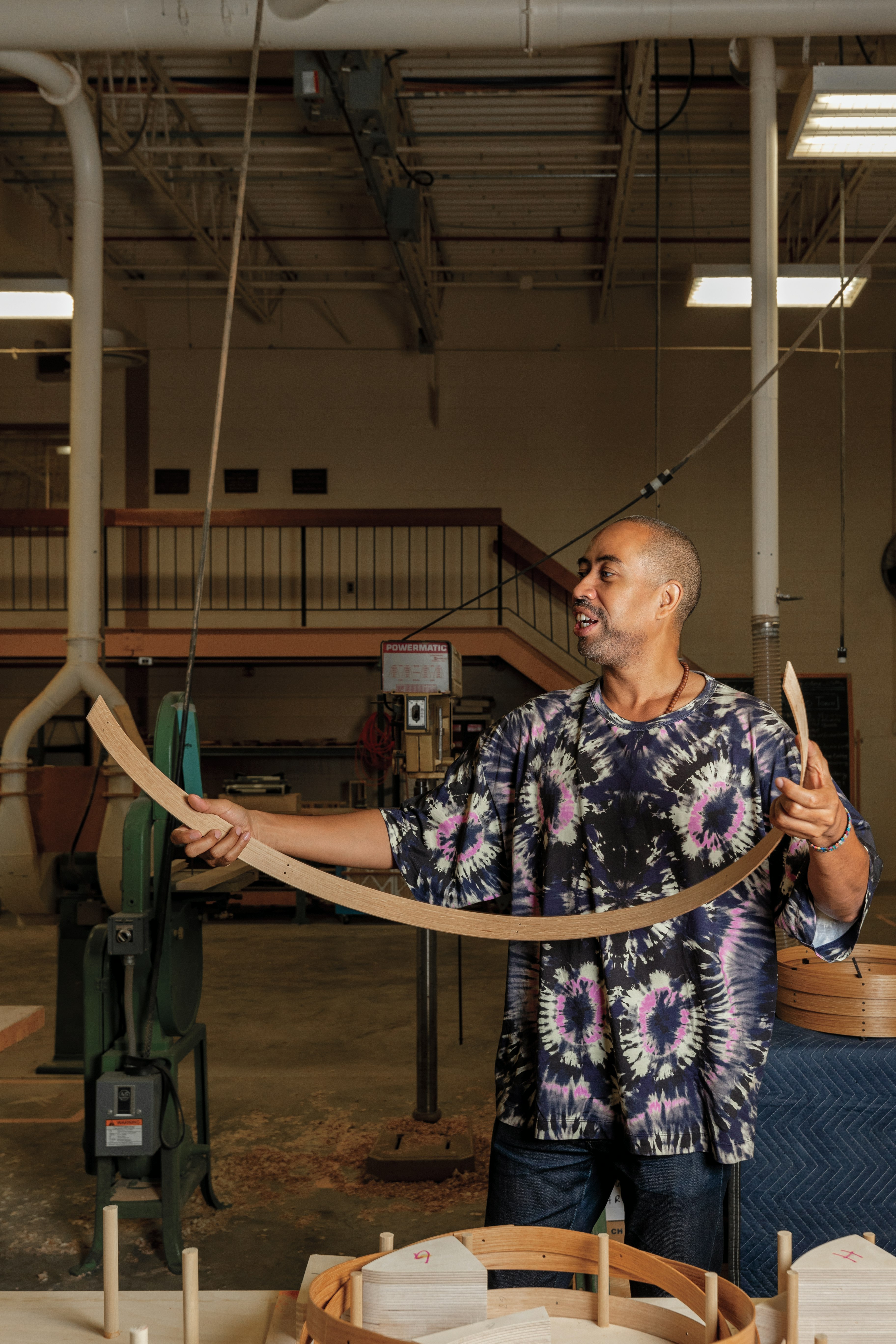 Stephen Burks holding  bent white oak wooden basket band