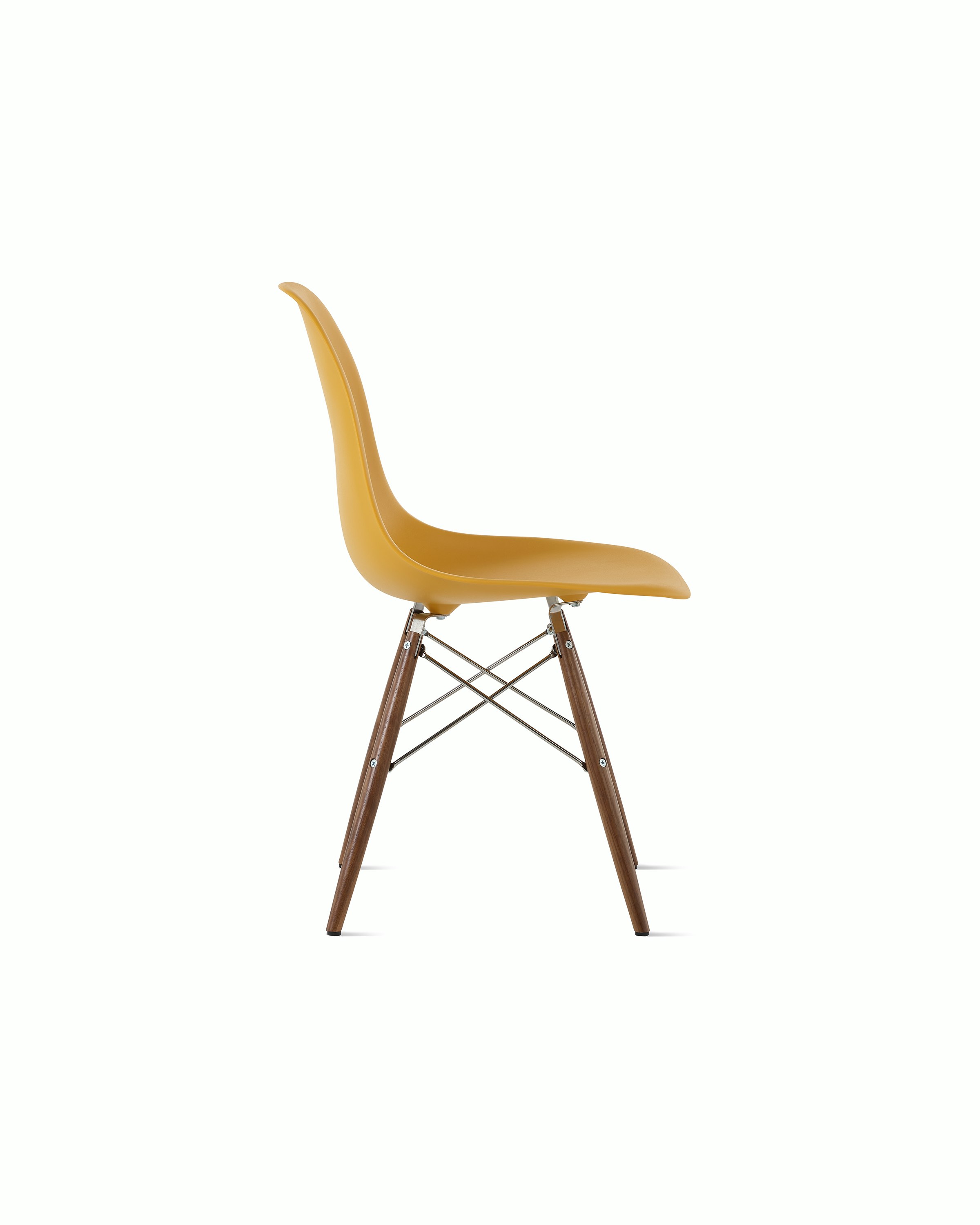 Side of deep yellow plastic shell chair on dowel-base legs.