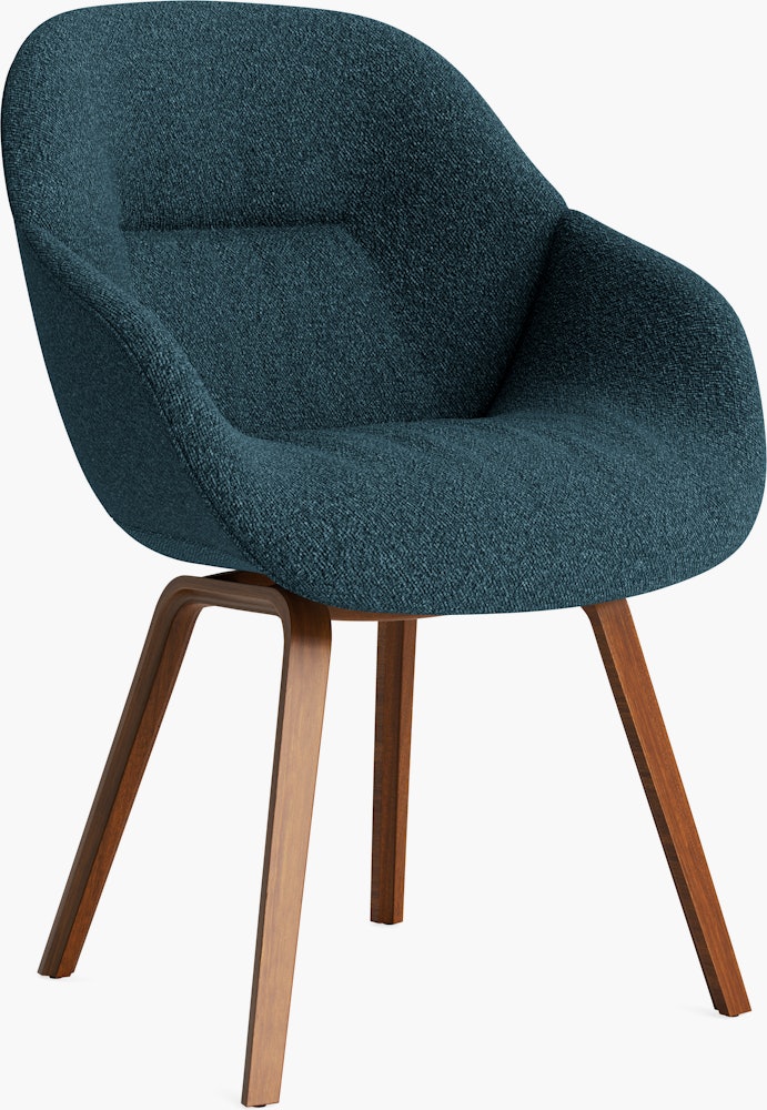 A front angle view of the AAC 123 Soft About A Chair Upholstered Armchair with a wood base.