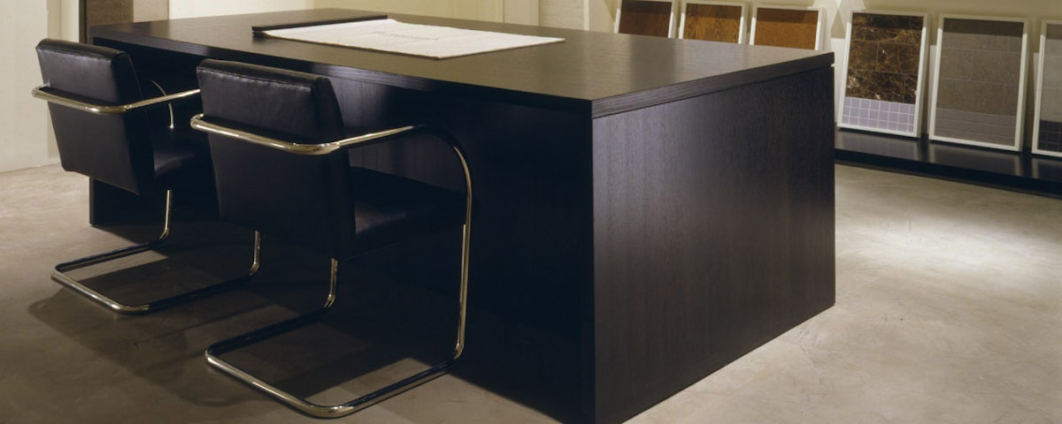 Brno Tubular Chairs surrounding a dining room table with bananas on top of it