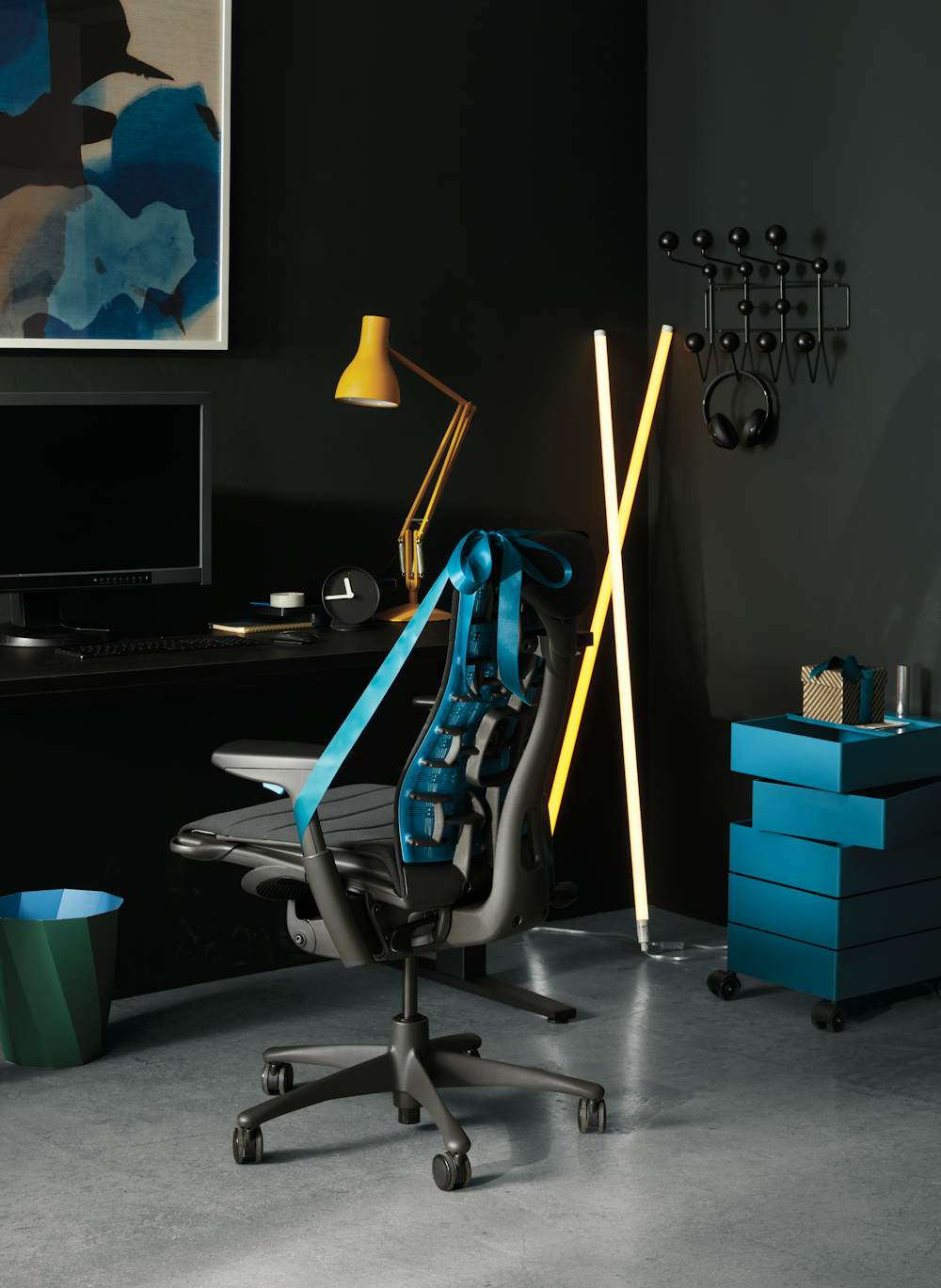 Embody Gaming Chair, Motia Gaming Sit-to-Stand Desk, Type 75 Desk Lamp and Neon Tube LED Lights in a home setting