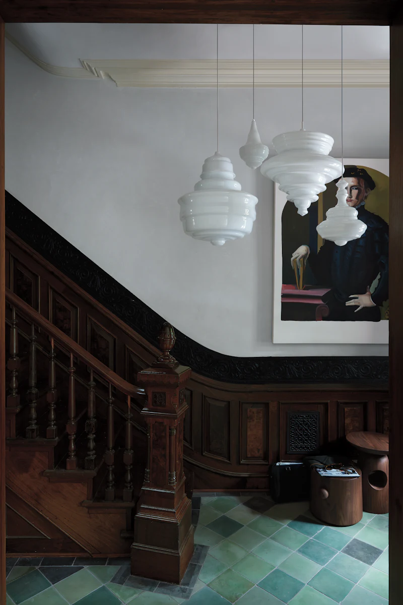 White modern pendant lamps hanging from ceiling in a dark ornate interior