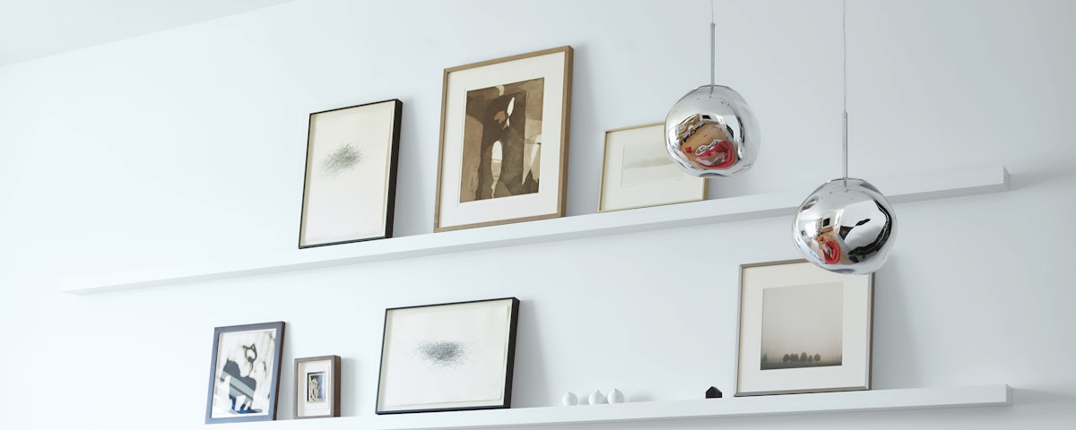 Two Melt Pendants suspended in front of wall shelving in a living room setting