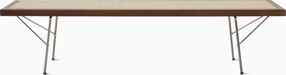 A Nelson Cane Bench with a walnut frame and metal legs, viewed from the long side.