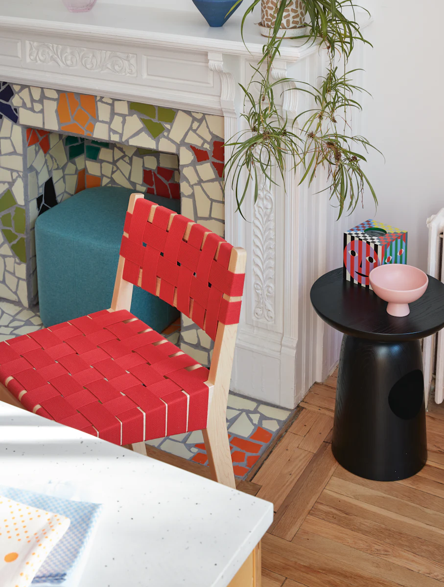 Mosaic fireplace surround with colorful tiles and a red chair rail
