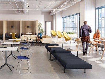 A brightly lit community space featuring three people utilising a variety of colourful seating options including the HAY Uchiwa Lounge Chair, Muuto Base Tables and Muuto Still Cafe Tables