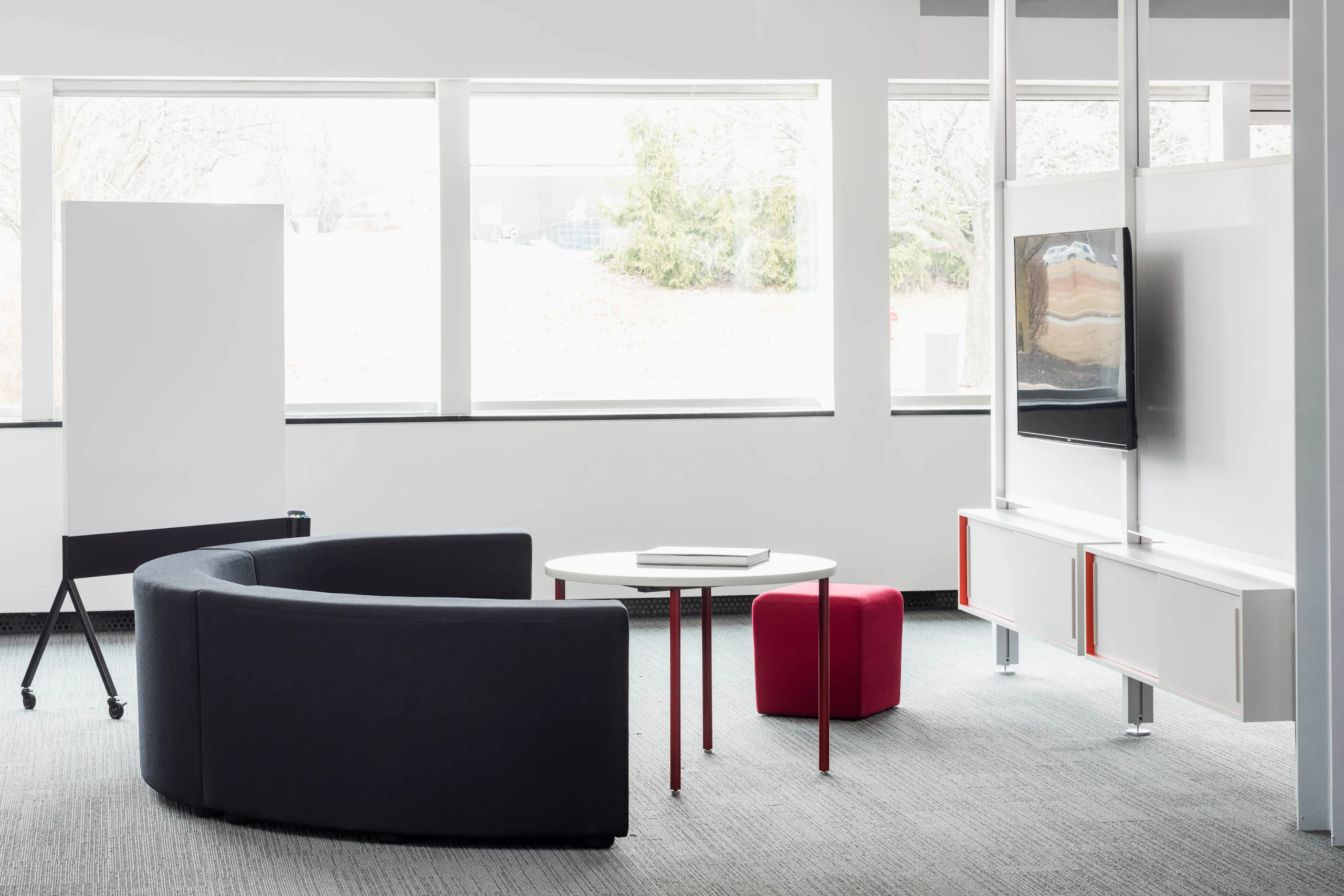 Knoll Interpole with grey k lounge and red Antenna Simple Table for Activity Spaces and other meeting spaces.