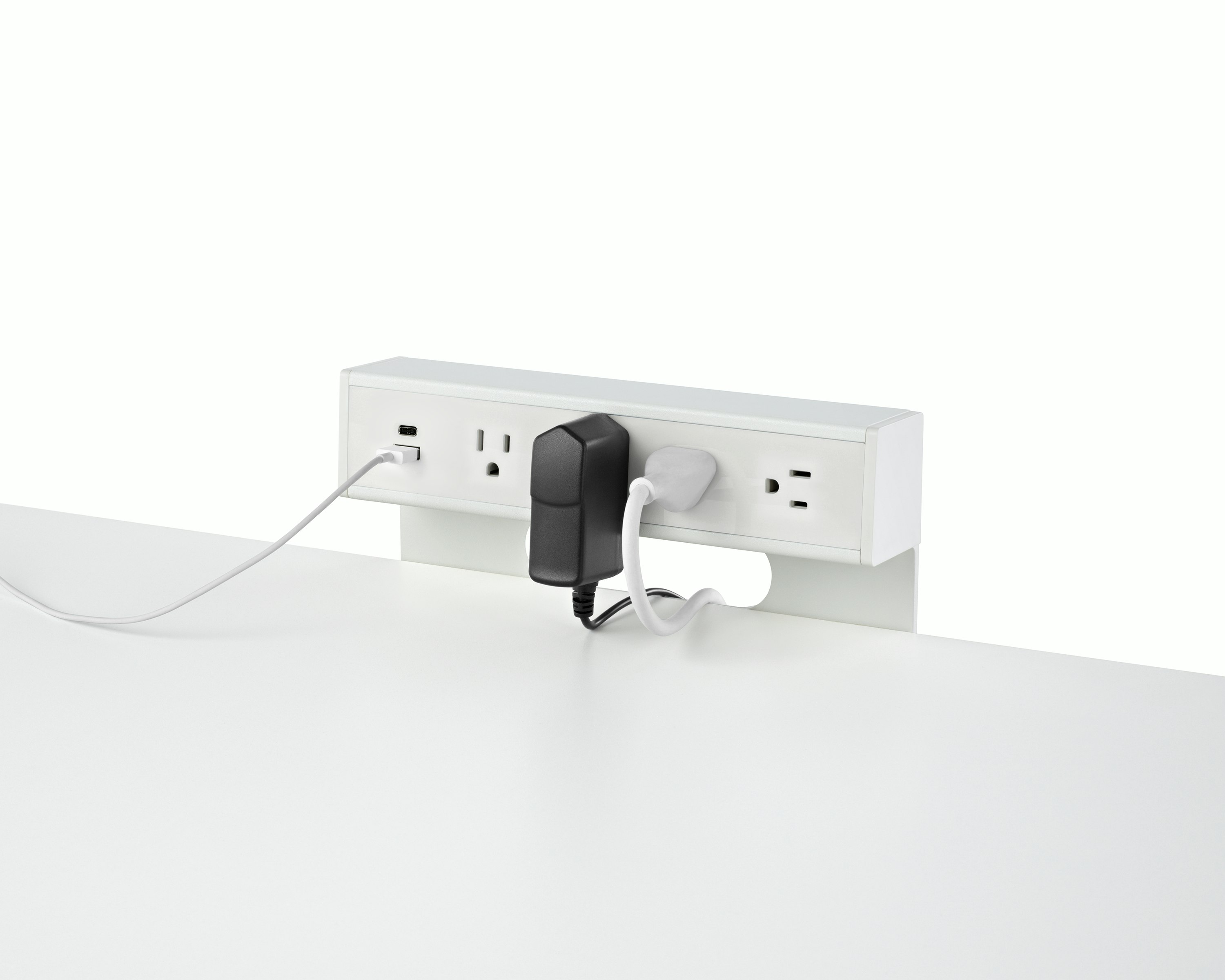 USB-A port and cable, USB-C port, and four A/C power outlets with two cables plugged into an attached table power source.
