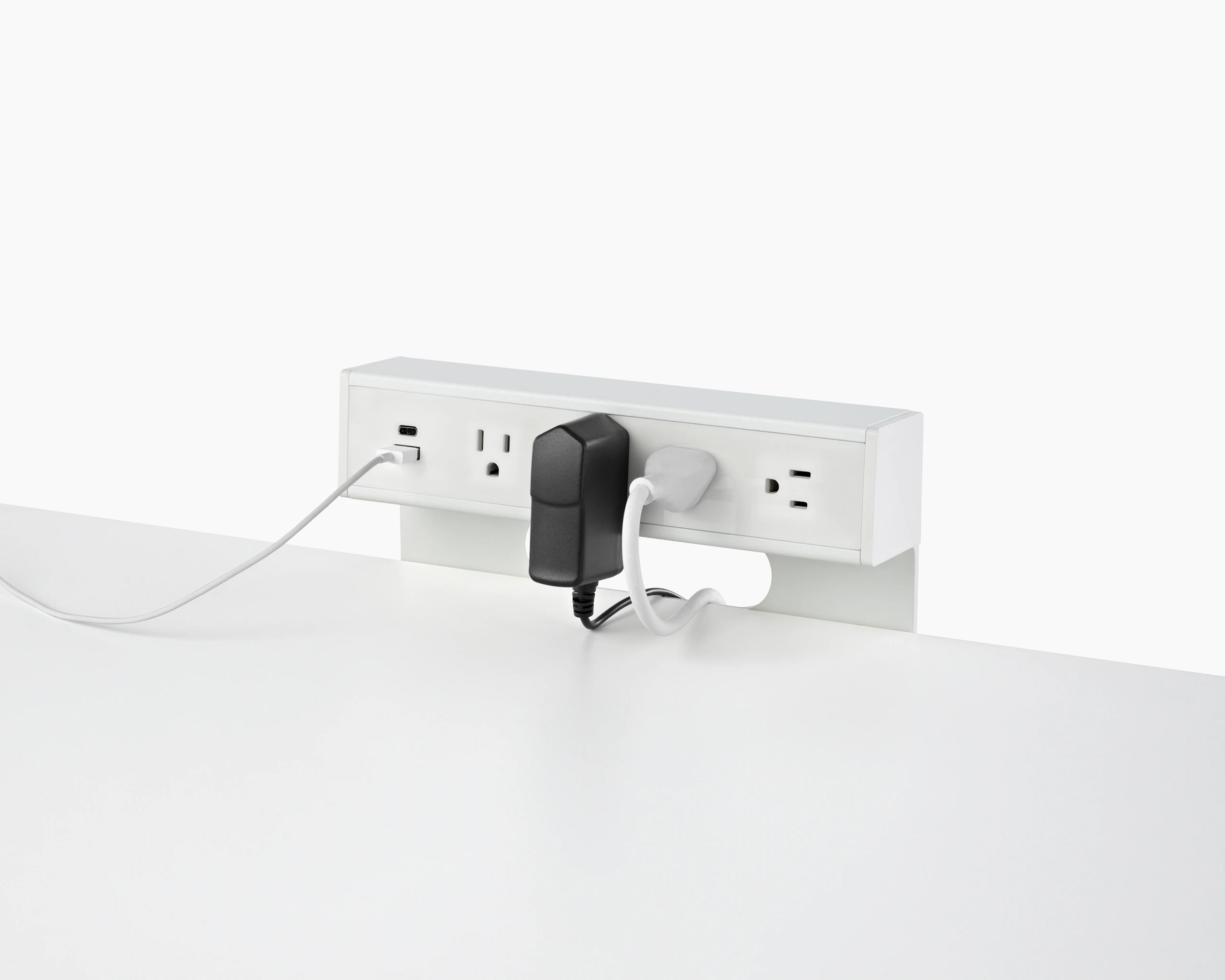 USB-A port and cable, USB-C port, and four A/C power outlets with two cables plugged into an attached table power source.