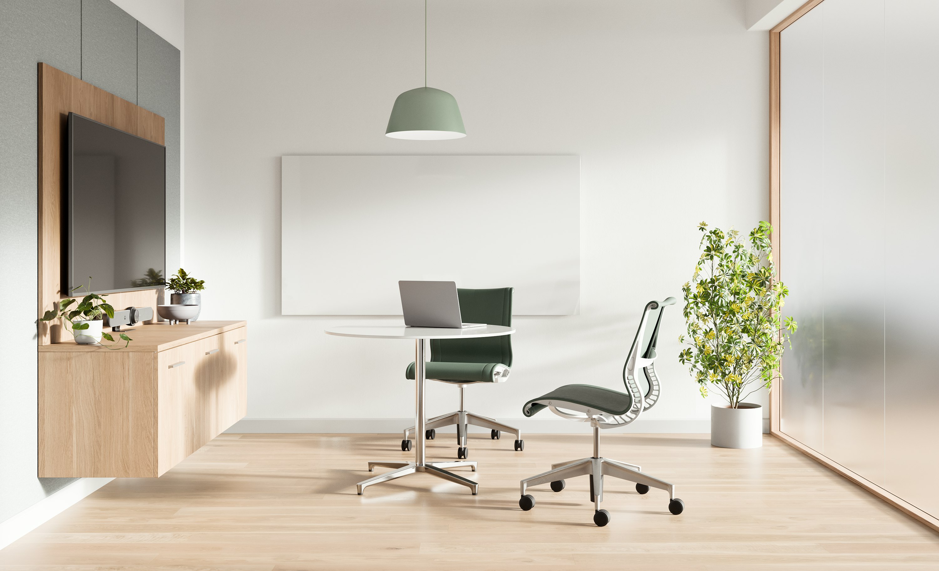 Telemedicine space with Mora casework wall unit , two Setu chairs with green upholstery and a round white table.