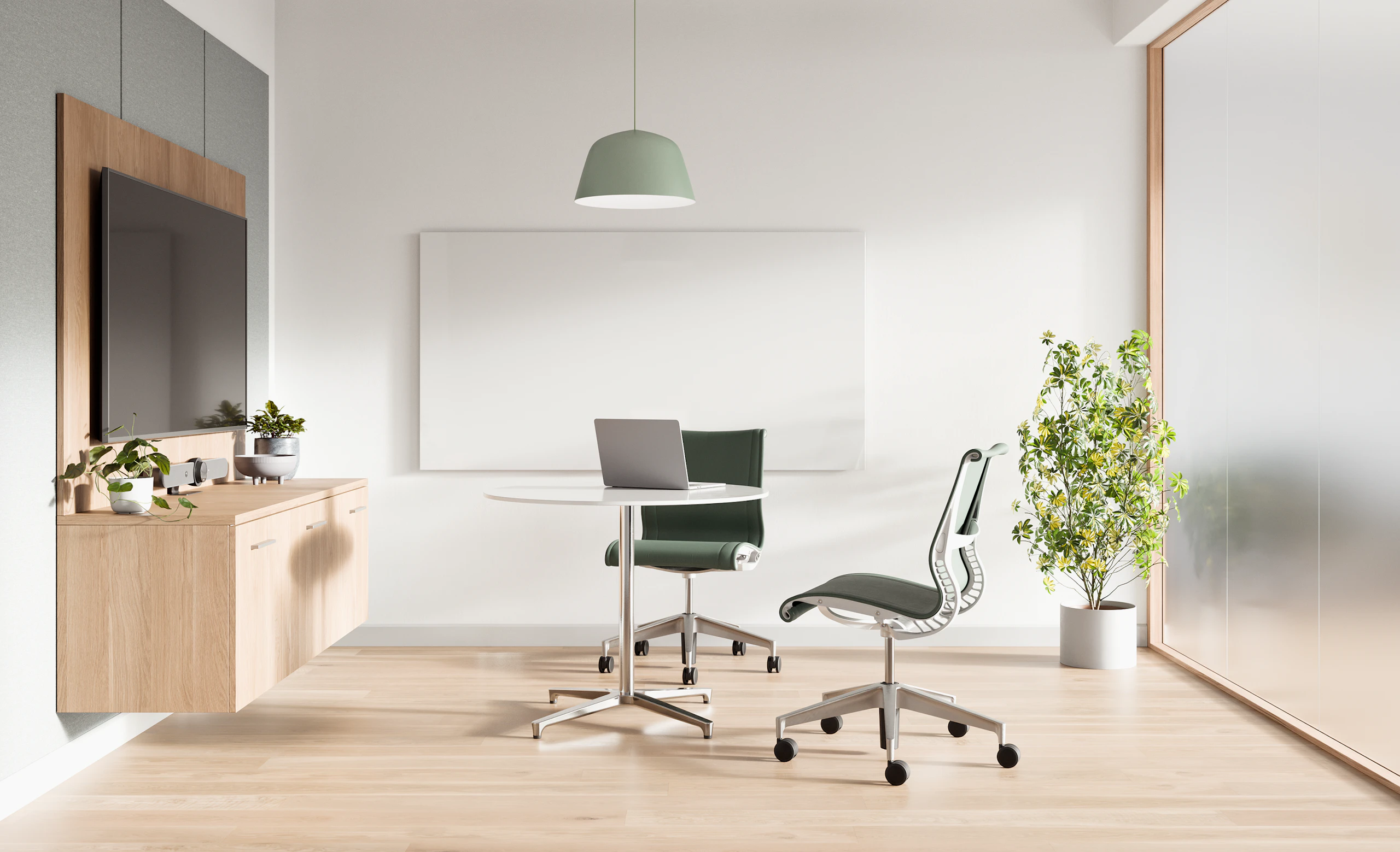 Telemedicine space with Mora casework wall unit , two Setu chairs with green upholstery and a round white table.