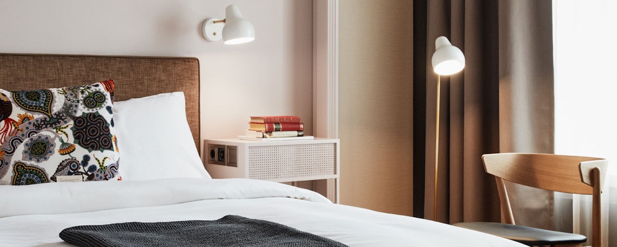 VL38 Floor Lamp next to a bed in a bedroom