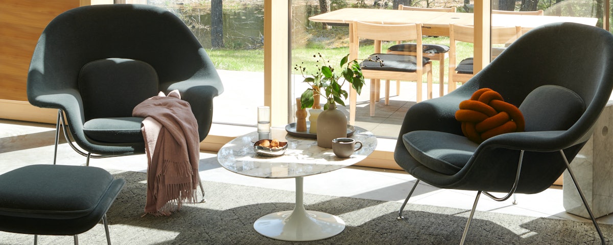 Womb Chair and Ottoman and Saarinen Coffee Table in living room setting