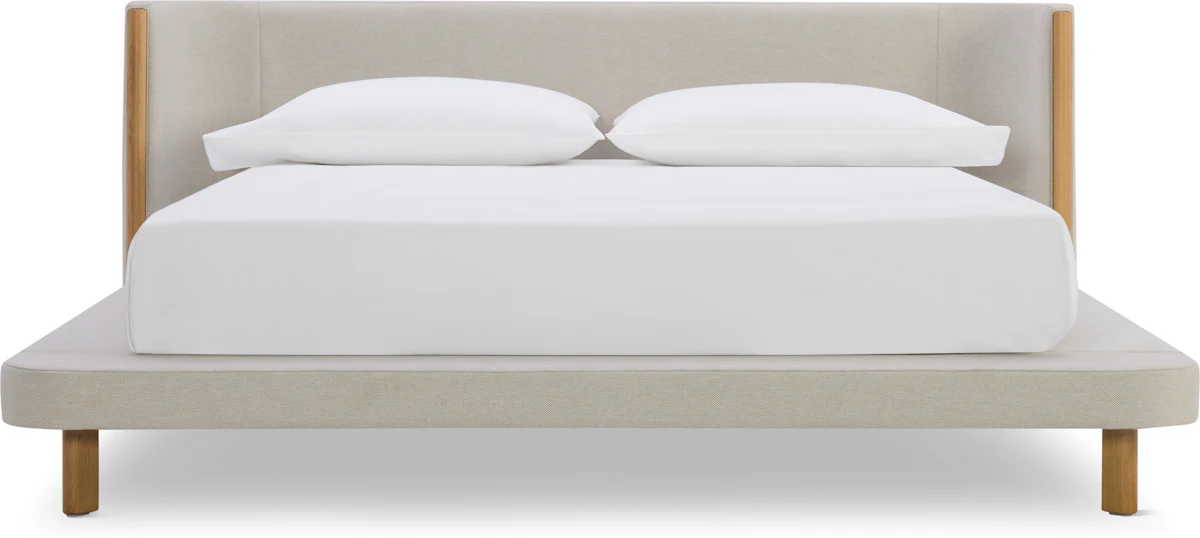 White upholstered headboard with light wood frame and short wooden legs.