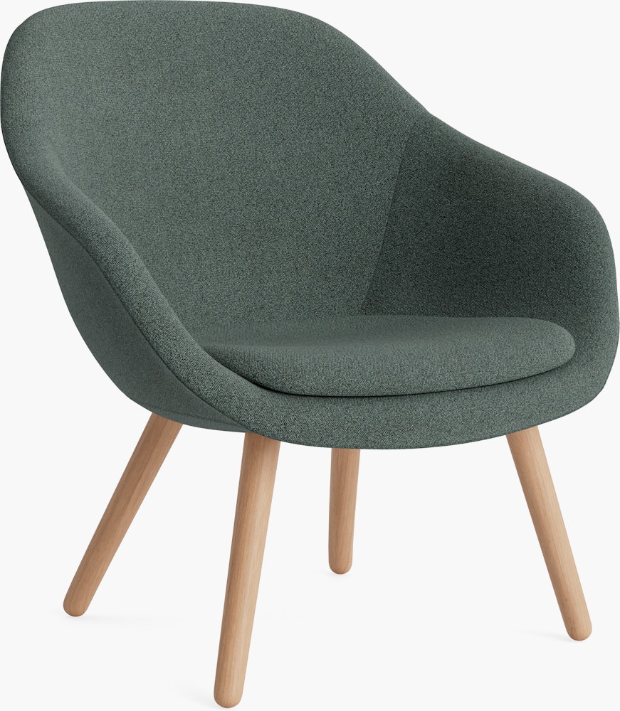 A soft green About a Lounge 82 Armchair with low back viewed from an angle