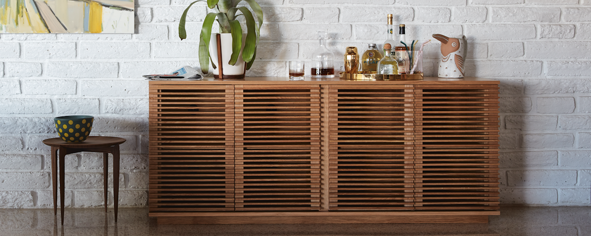 Line Credenza holding assorted barware in a living room setting