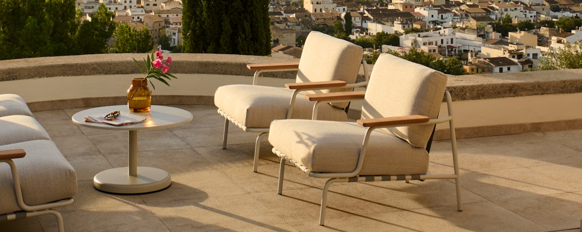 Settle Outdoor Lounge Chairs and Settle Outdoor Sofa in a stone patio setting