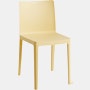 A three quarter angle view of a yellow Elementaire Side Chair.