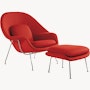 A fire red Womb Chair & Ottoman viewed from an angle.