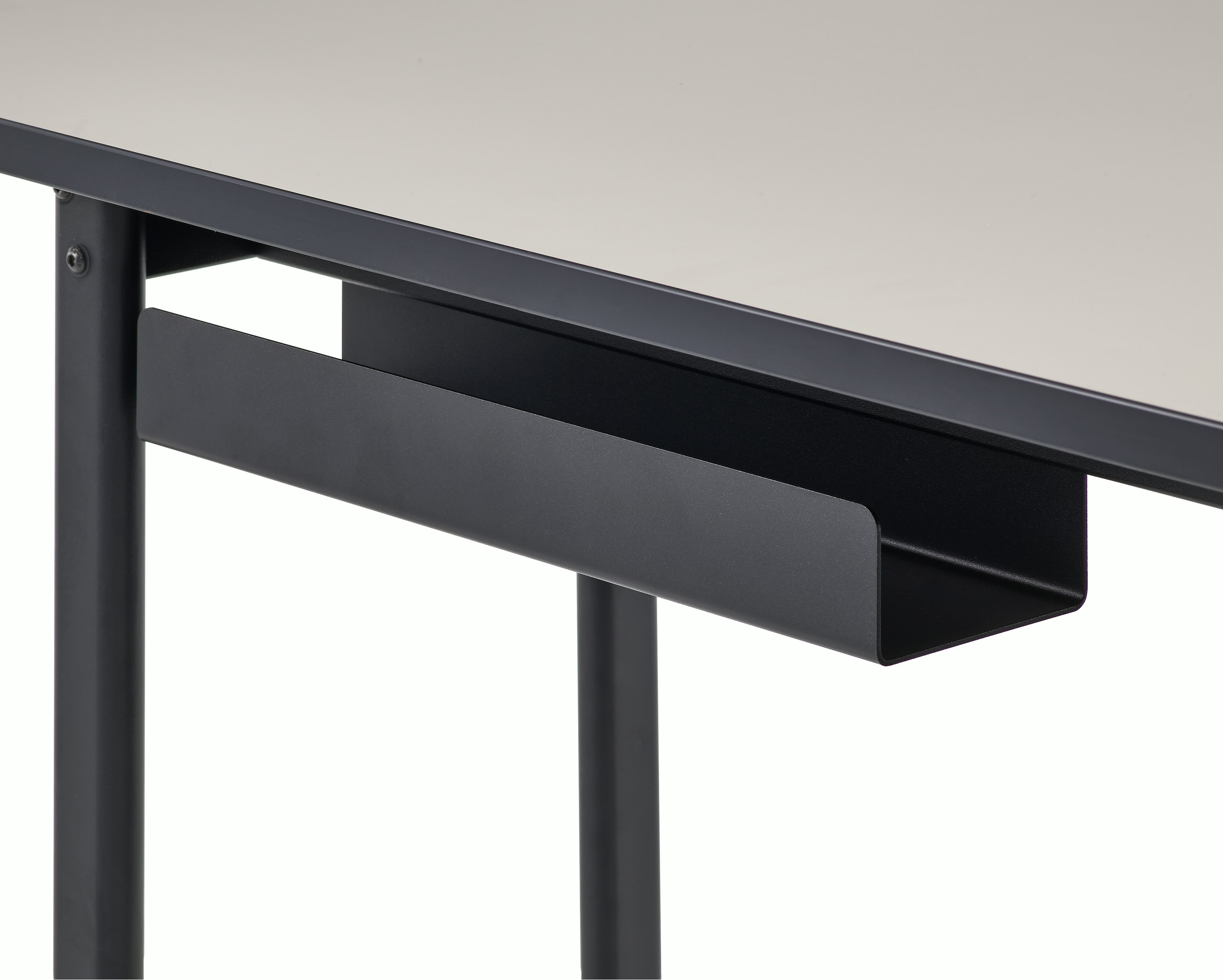 Detail view of the cord management on a Mode desk in black with sandstone top.