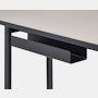 Detail view of the cord management on a Mode desk in black with sandstone top.