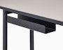 Detail view of the cord management on a Mode desk in black with sandstone top.
