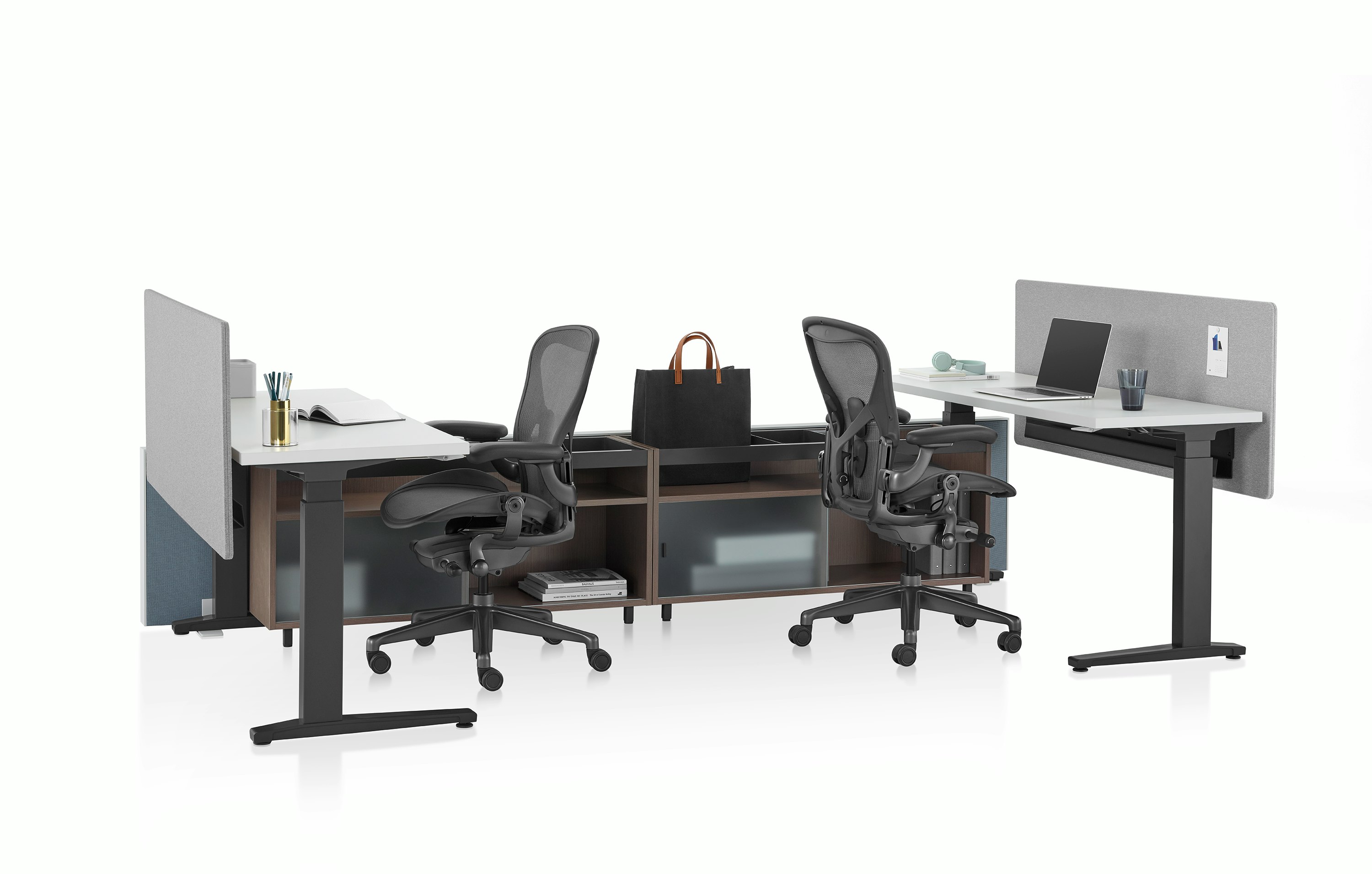 Dark green Canvas Channel with lower storage, Motia Sit-to-Stand Tables with white surface, gray screens, and black Aeron chairs
