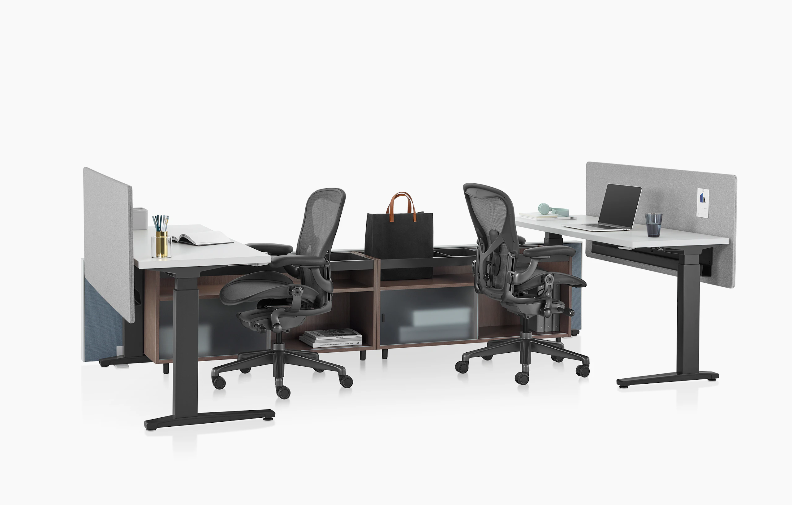 Dark green Canvas Channel with lower storage, Motia Sit-to-Stand Tables with white surface, gray screens, and black Aeron chairs