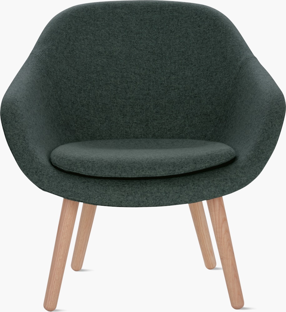 A soft green About a Lounge 82 Armchair with low back viewed from the front