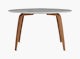 A carrara round Organic Dining Table with walnut base with walnut base viewed from the front