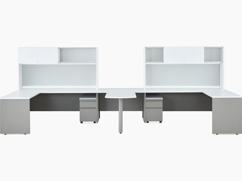 Two white and gray Canvas Metal Desks with upper storage and a peninsula surface.