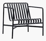 A three quarter view of a Palissade Lounge Chair, Low in dark grey. A three quarter view of a Palissade Lounge Chair, Low in dark grey.