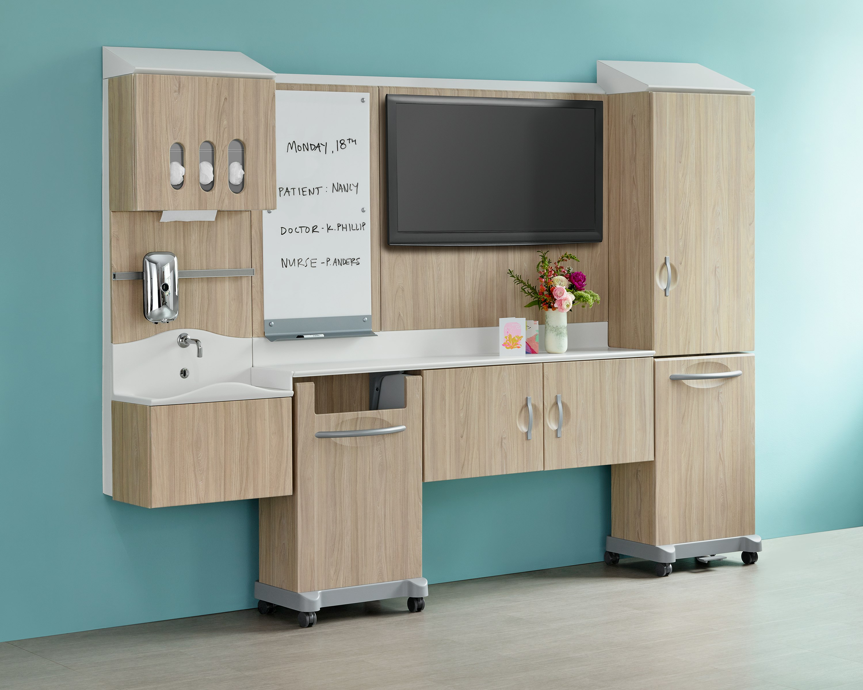 A light wood finish Compass System footwall in patient room setting.
