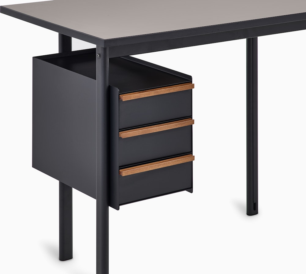 Detail view of drawers in black with walnut pulls on a Mode desk.