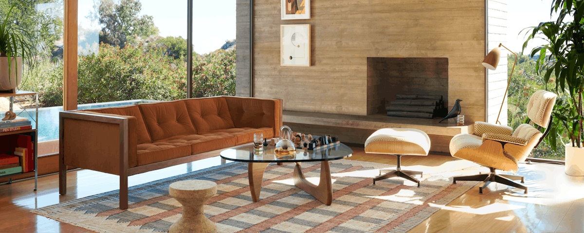 Ventana Flatweave Jute Rug, Cube Sofa, Noguchi Table, Eames Lounge and Ottoman, and Nelson Bubble Pendant in a living room setting