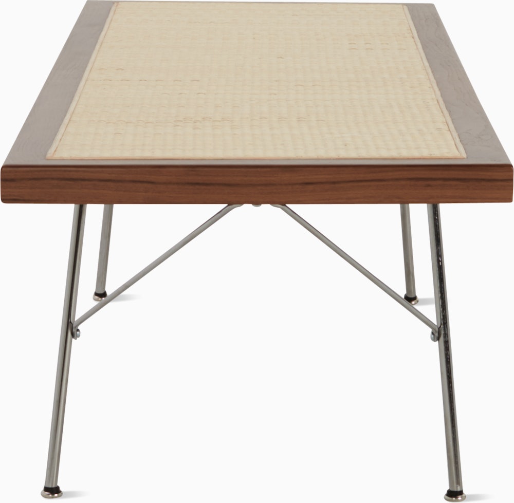 A Nelson Cane Bench with a walnut frame and metal legs, viewed from the short side.