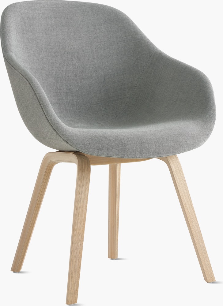 A front angle view of the AAC 123 About A Chair Upholstered Armchair Wood Base.
