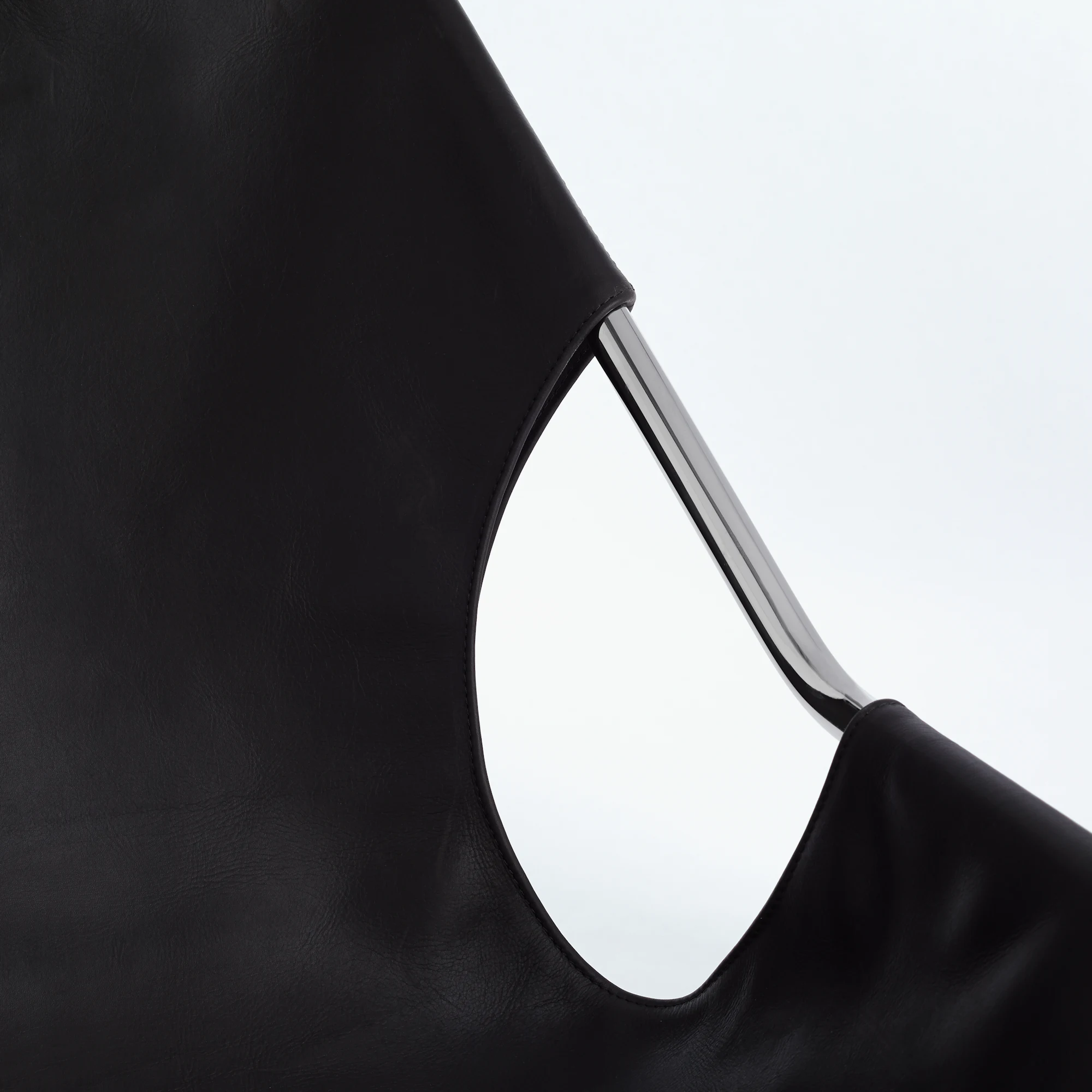 Paulistano armchair close-up of black upholstery and chrome frame