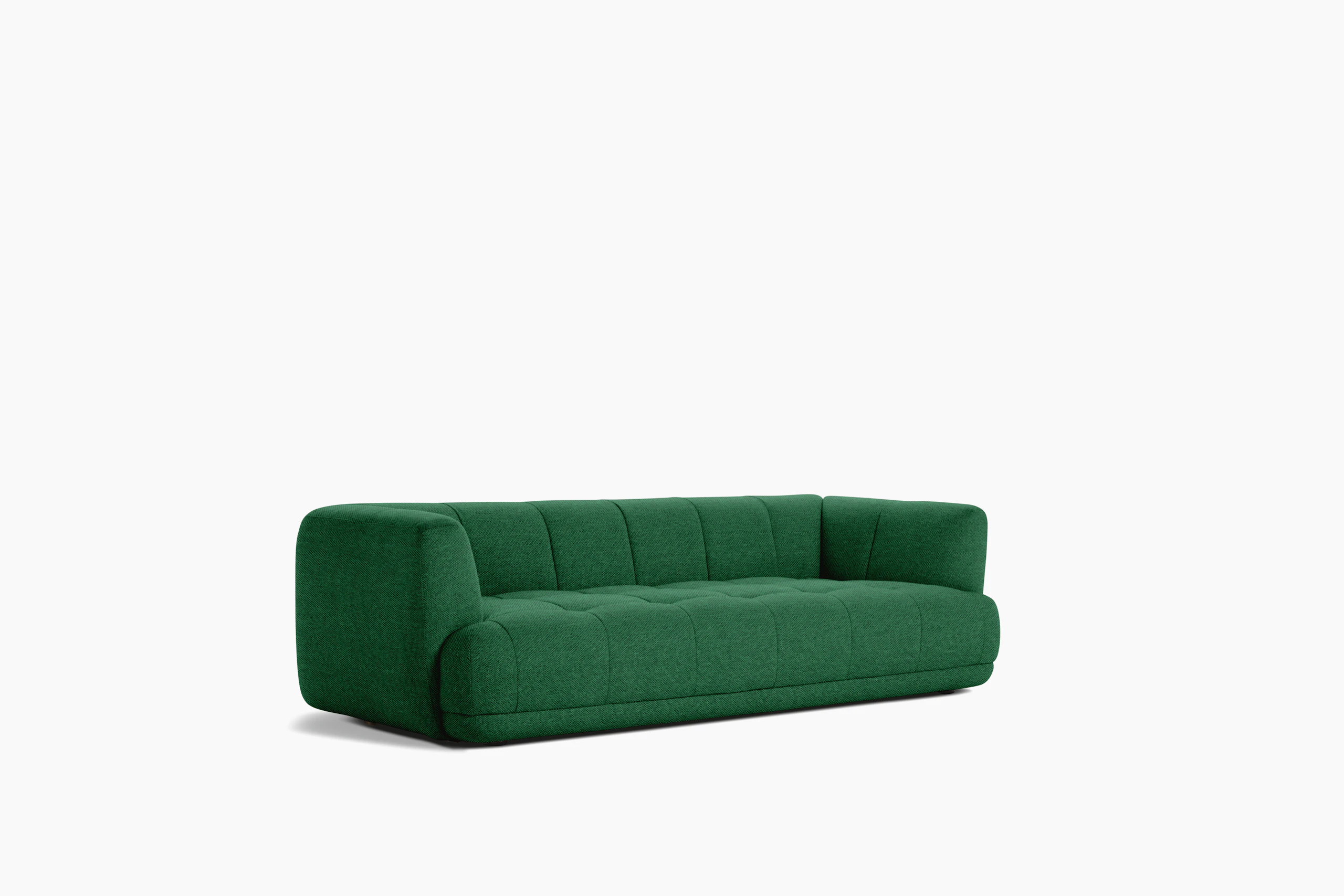 A front angle view of an emerald Quilton Sofa.
