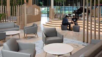 Two visitors sitting in the lobby at Fakeeh University Hospital in Dubai.