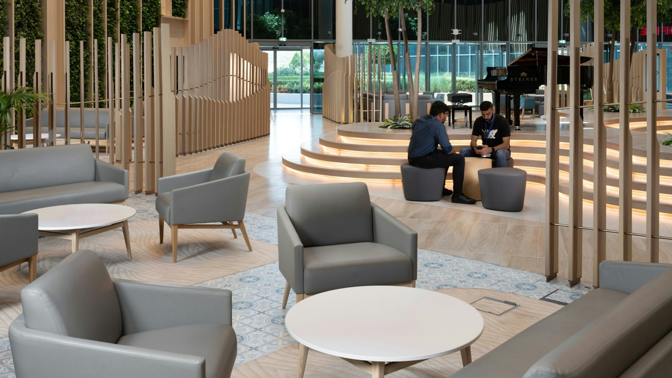 Two visitors sitting in the lobby at Fakeeh University Hospital in Dubai.