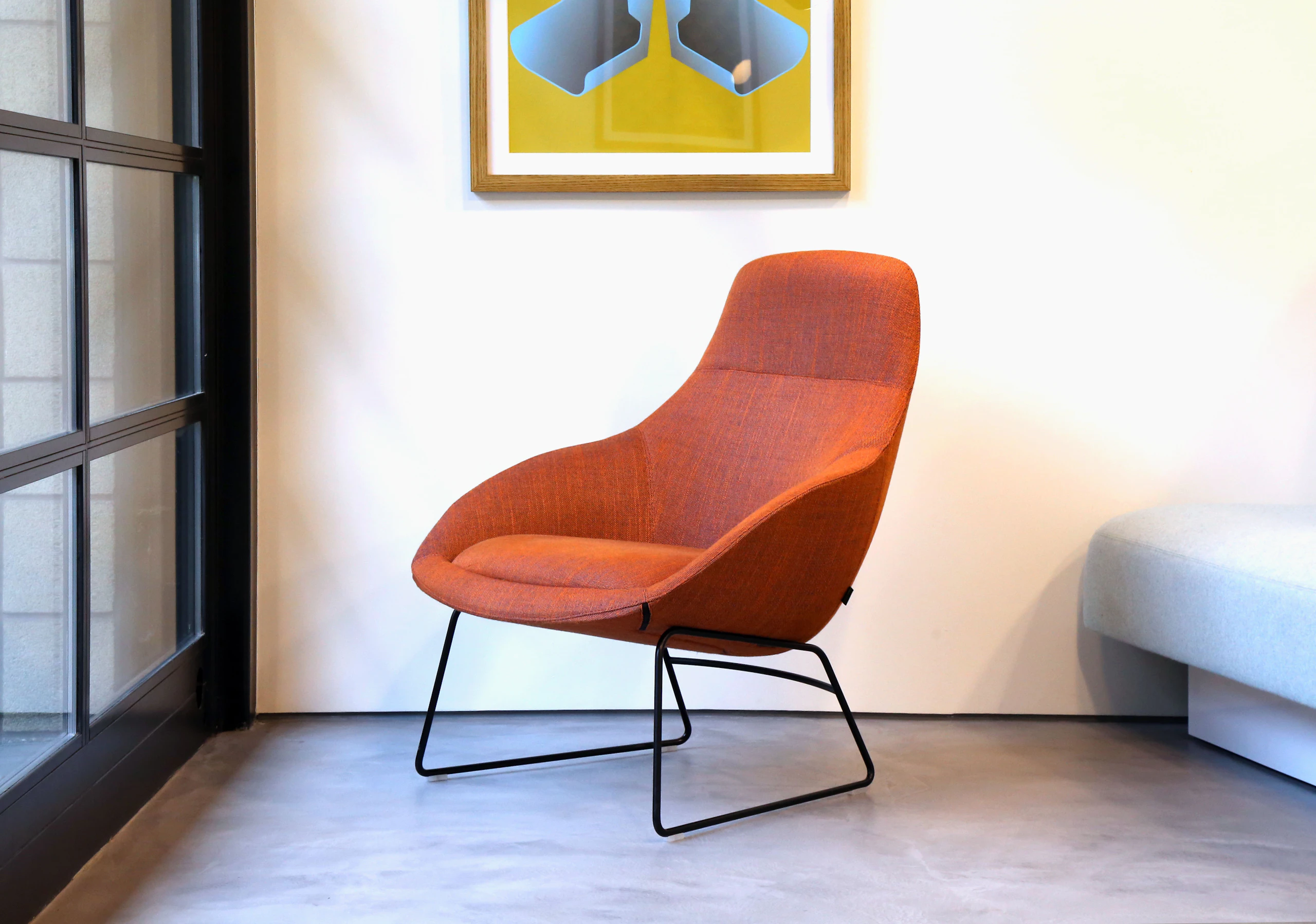 A naughtone Always Lounge Chair with a back steel sled base and patterned red upholstery, viewed at an angle.