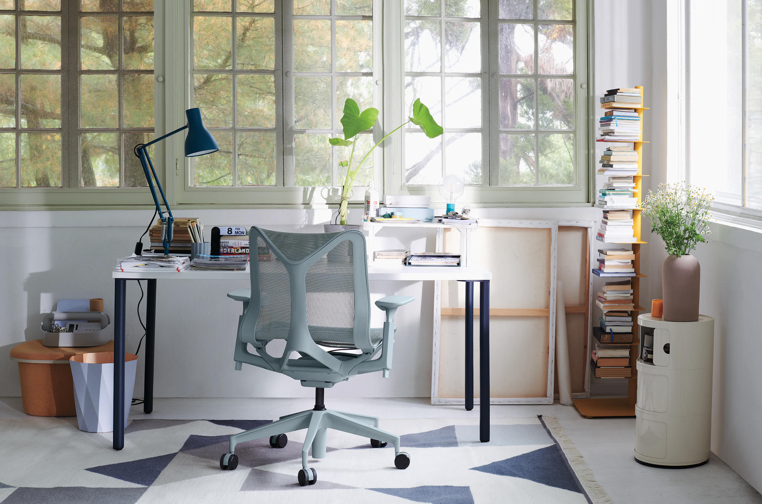 Blue and white OE1 Rectangular Table with a light grey low-back Cosm Chair in a home office setting.