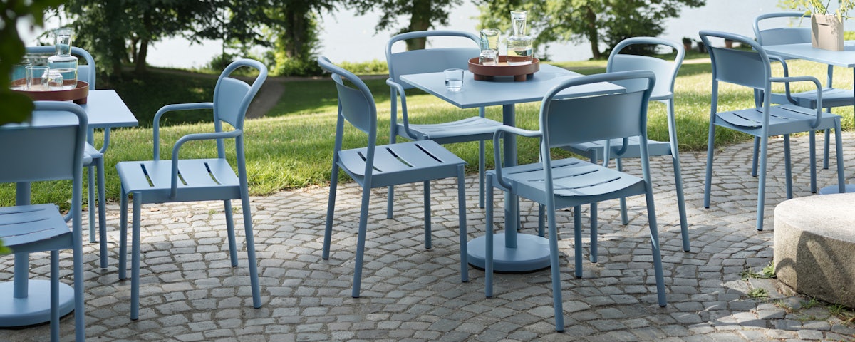 Linear Steel Chairs and Cafe Tables in an outdoor setting