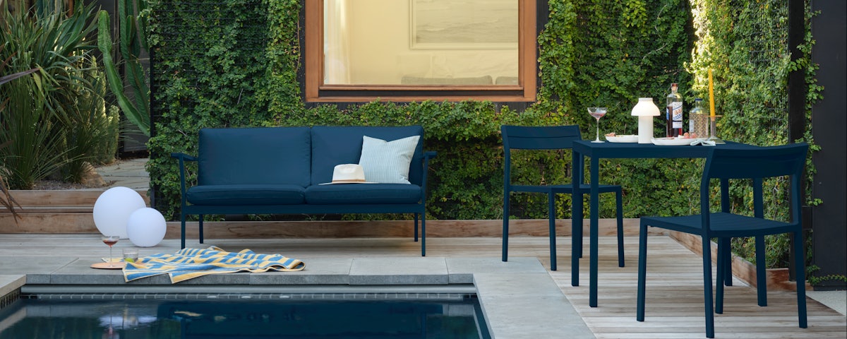 Eos Two Seater Sofa, Eos Square Dining Table and Eos Side Chair by the pool