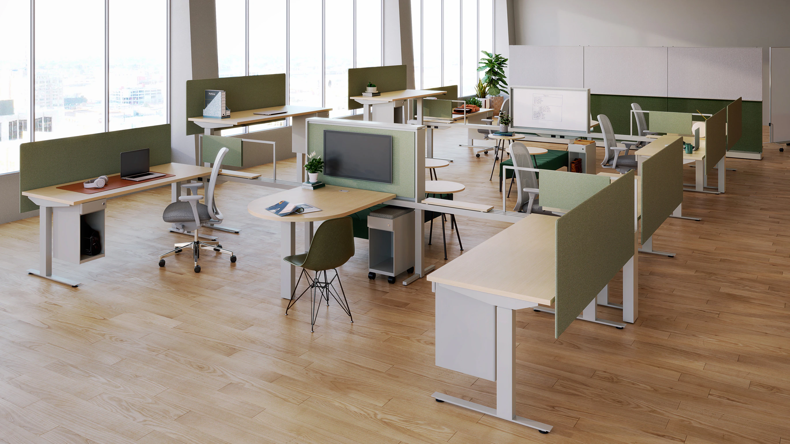 An open office with minimalist design, featuring Ambit Workspace Solutions in green fabric hues and light grey finishes.
