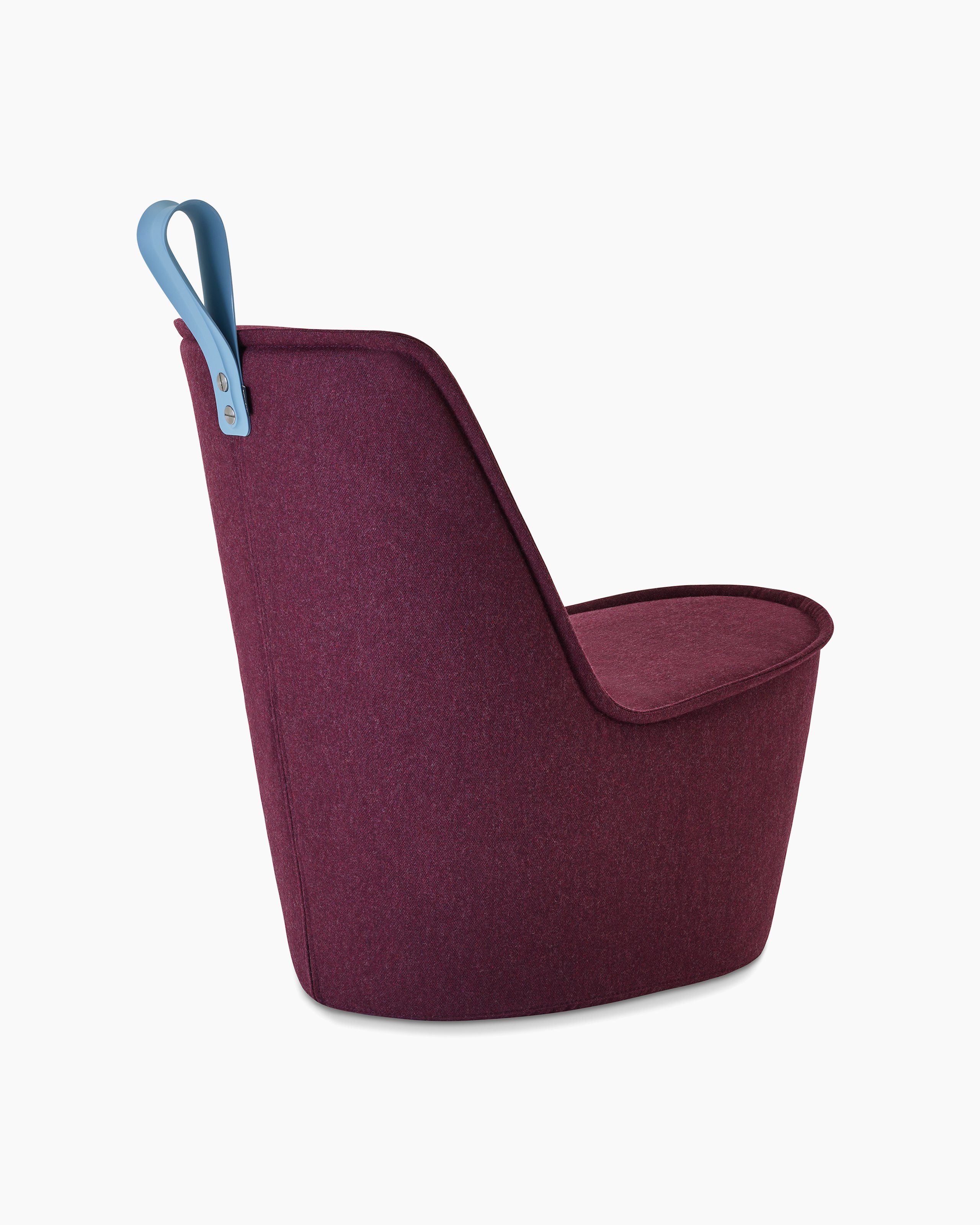 A deep burgundy upholstered lounge chair with pastel blue handle.