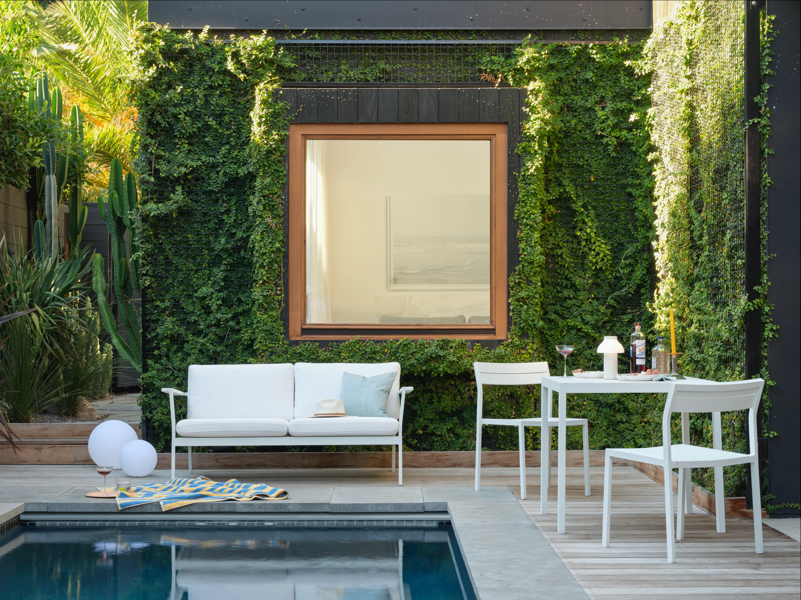 Eos Two Seater Sofa, Eos Square Dining Table and Eos Side Chair by the pool