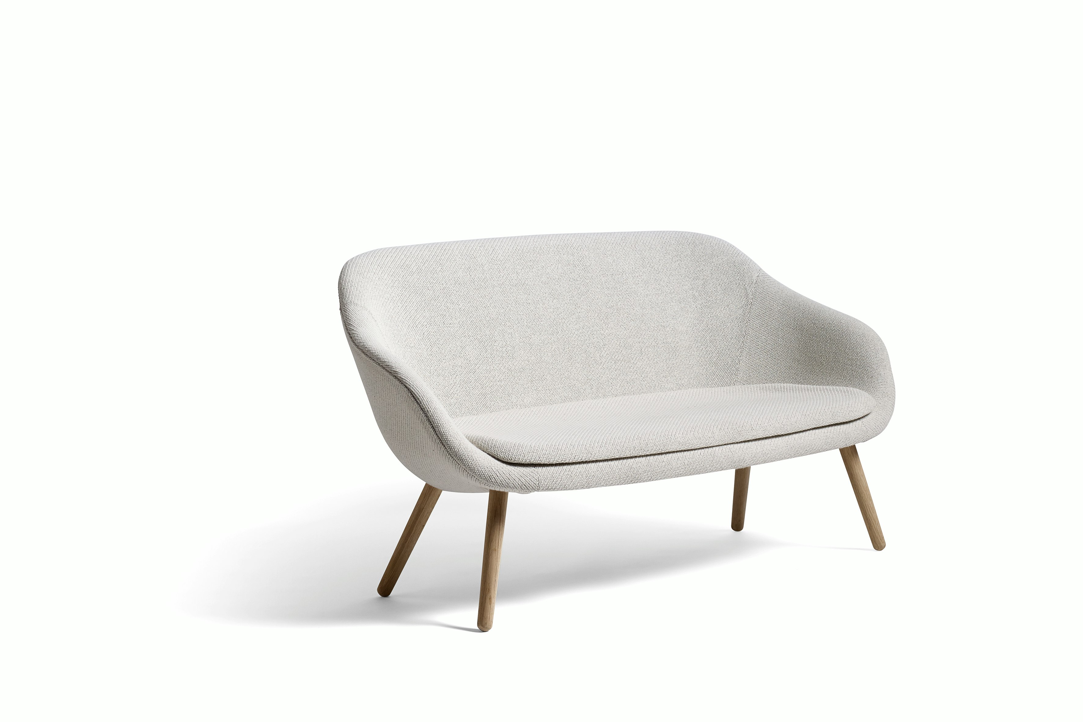 A gray About a Lounge Sofa with wooden legs, viewed from the side.